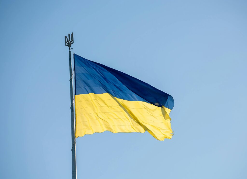 A close-up of the Ukrainian flag waving proudly against a clear blue sky.